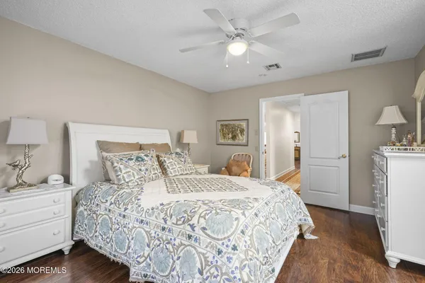 a bedroom with a large bed and a chandelier