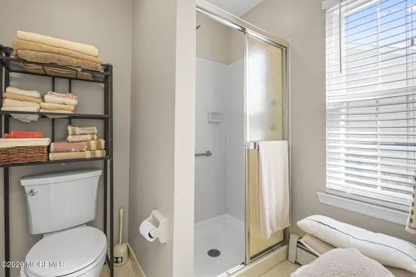 a bathroom with a toilet and a shower