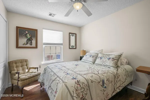 a bed sitting in a bedroom next to a window