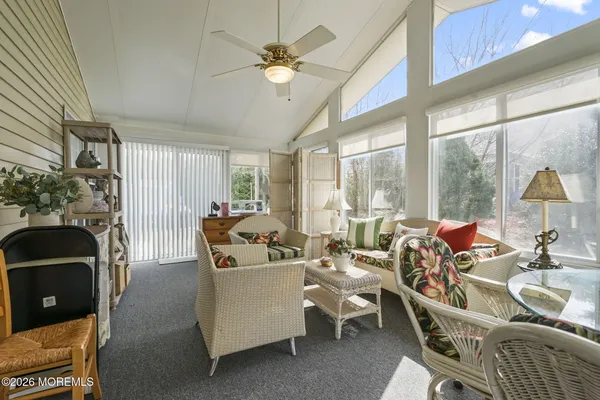 a living room with furniture a fireplace and a large window