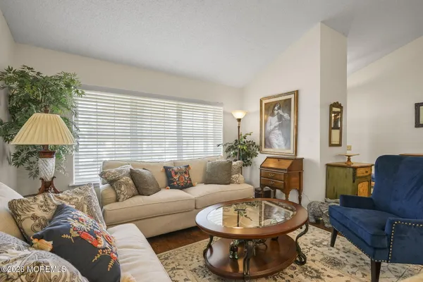 a living room with furniture and a lamp