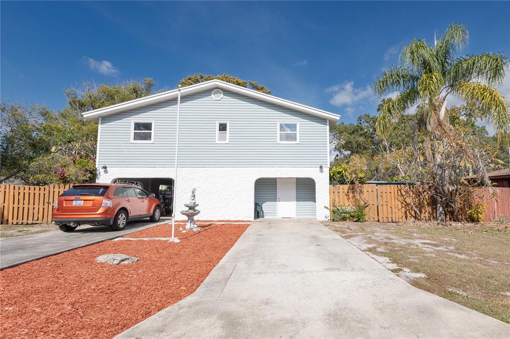 a view of house with outdoor space and parking