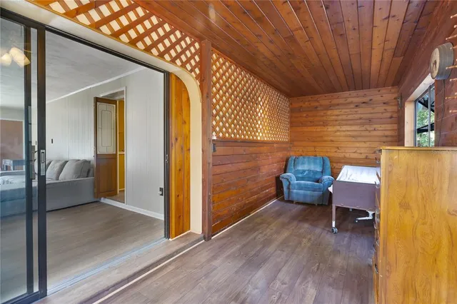 a view of a entryway door with furniture and wooden floor