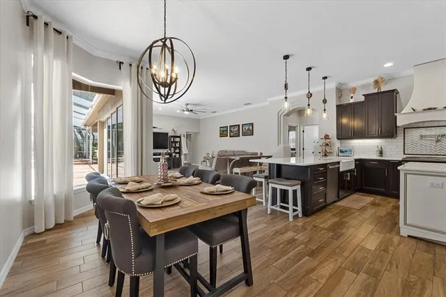 a view of a dining room with furniture wooden floor and chandelier