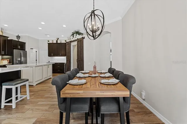 a bedroom with a bed and a flat tv screen on a dresser