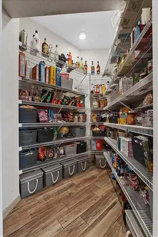 a bathroom with a granite countertop toilet a sink and a mirror
