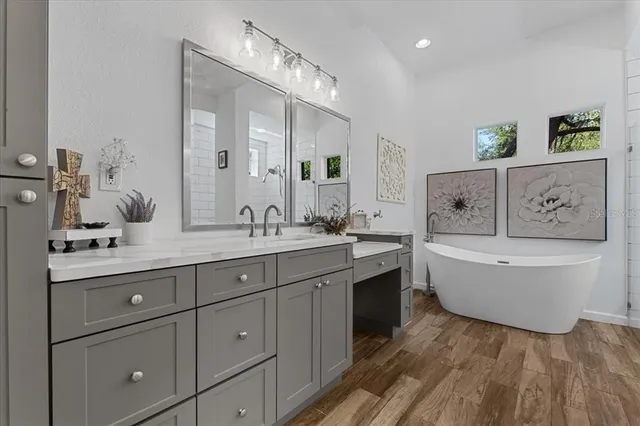 a kitchen with stainless steel appliances a refrigerator a sink a stove a table and chairs