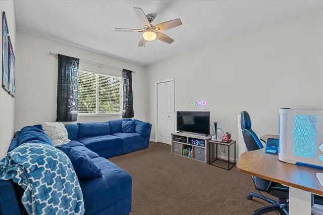 a view of a house with backyard and sitting area