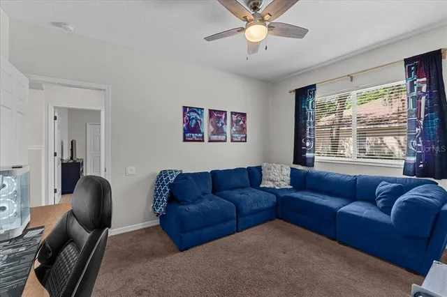 a view of a kitchen with furniture and a ceiling fan