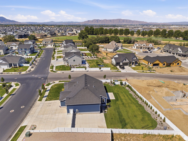 2786 West Hancock Street, Unit 198 Mapleton, UT 84664 - Photo 28 of 33 Property featuring a dark blue exterior with a dark gray roof, a white vinyl fence, and a concrete driveway