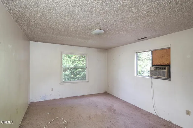 a view of an empty room with windows