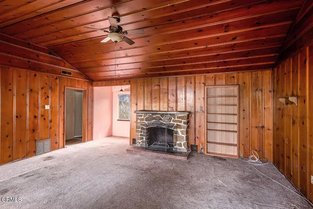 a view of an empty room with a fireplace