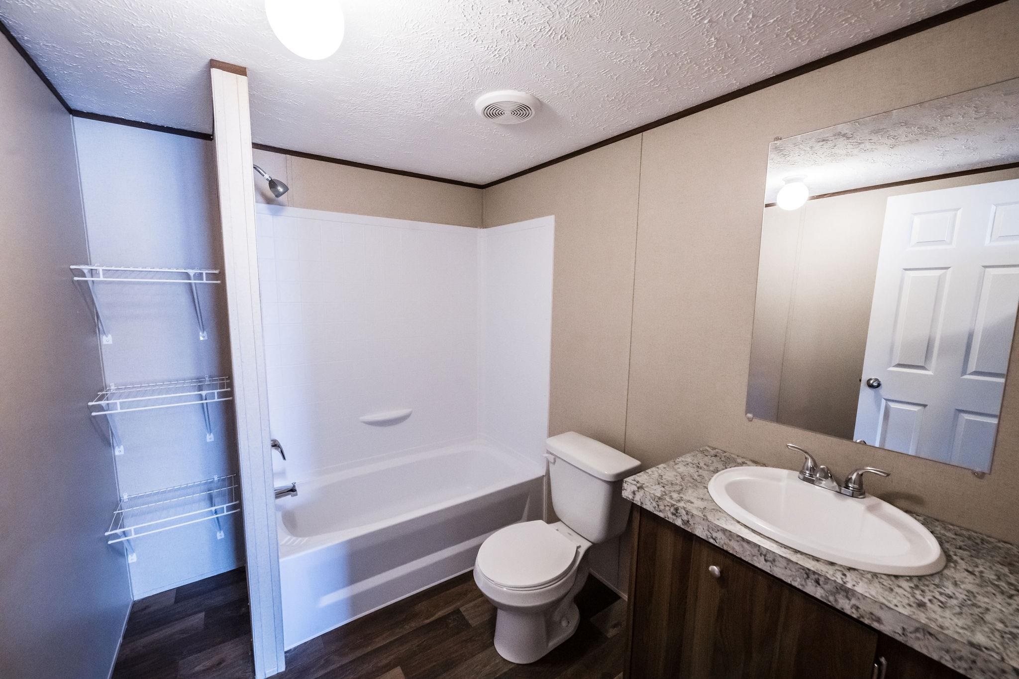 283 Clements Way Fruita, CO 81521 - Photo 14 of 16 a bathroom with a granite countertop sink toilet and shower