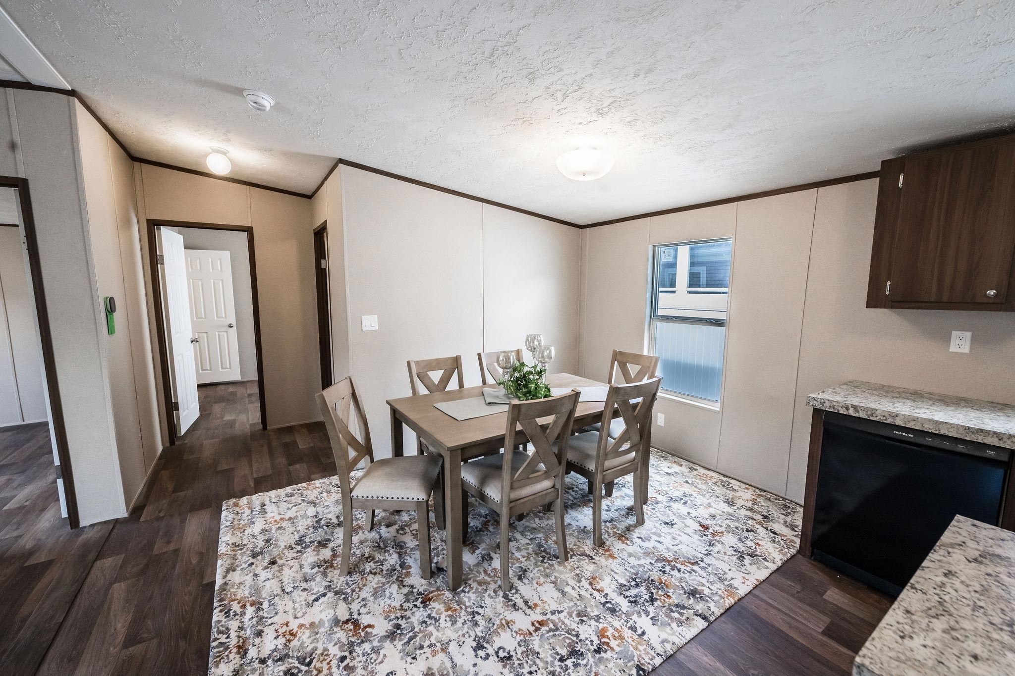 283 Clements Way Fruita, CO 81521 - Photo 5 of 16 a dining room with wooden floor and a rug