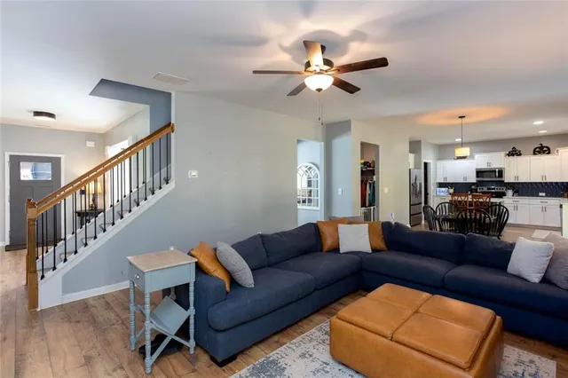 a living room with furniture and kitchen view