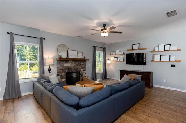 a living room with furniture flat screen tv and a fireplace