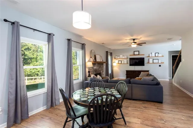 a living room with furniture a chandelier and a flat screen tv