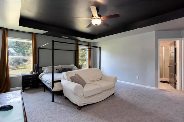 a spacious bedroom with a bed and a large window