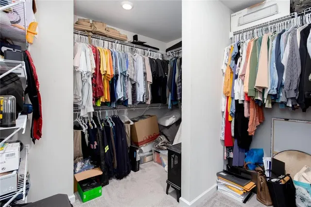 a bathroom with a granite countertop double vanity sink mirror and toilet
