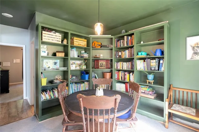 a dining room with furniture and a book shelf