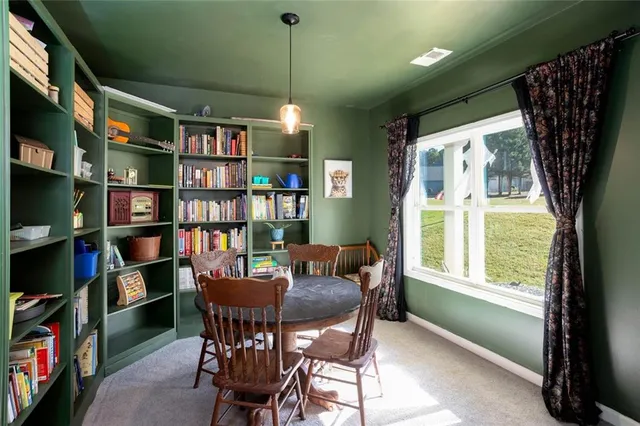 a view of a livingroom with furniture and a bookshelf