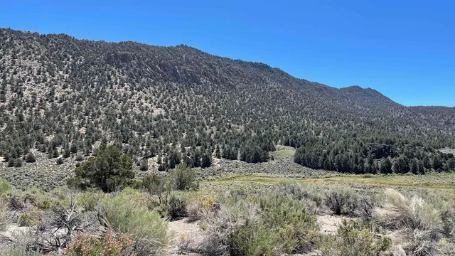 a view of a large mountain with mountains in the background