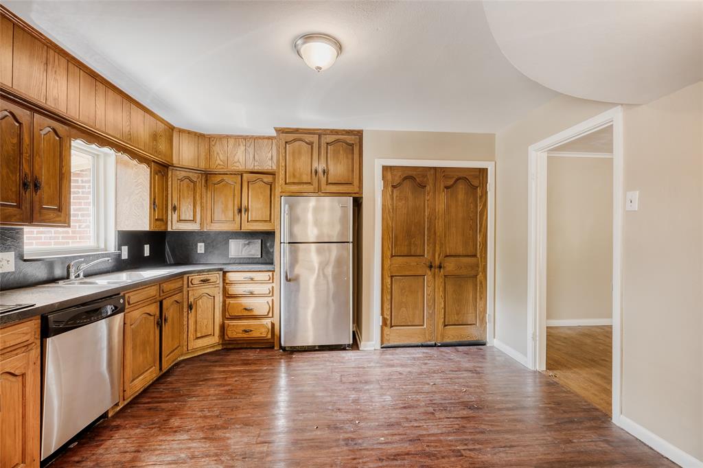 6612 East Mockingbird Lane Dallas, TX 75214 - Photo 12 of 28 a large kitchen with stainless steel appliances granite countertop a refrigerator and a sink