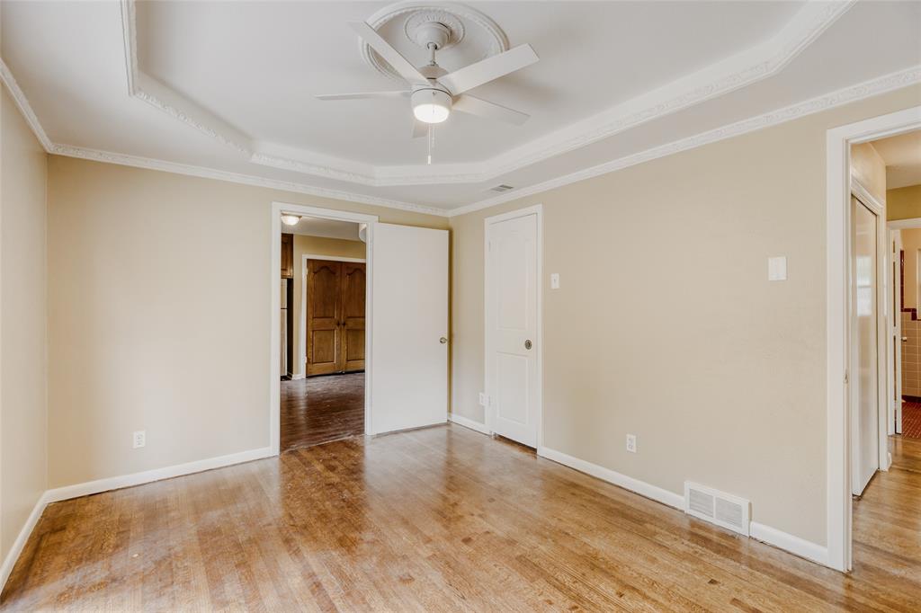 6612 East Mockingbird Lane Dallas, TX 75214 - Photo 14 of 28 an empty room with wooden floor and ceiling fan