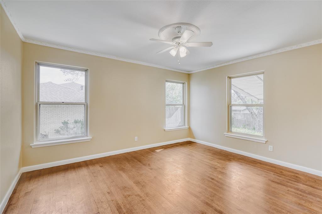 6612 East Mockingbird Lane Dallas, TX 75214 - Photo 19 of 28 a view of an empty room with a window and wooden floor