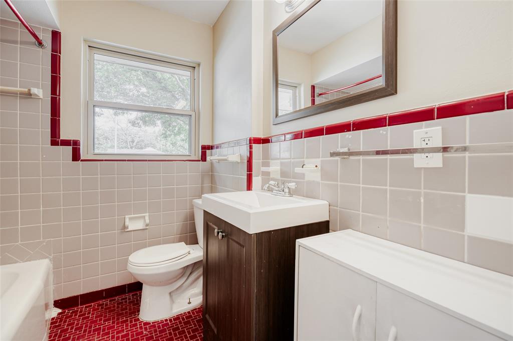 6612 East Mockingbird Lane Dallas, TX 75214 - Photo 21 of 28 a bathroom with a sink toilet and mirror