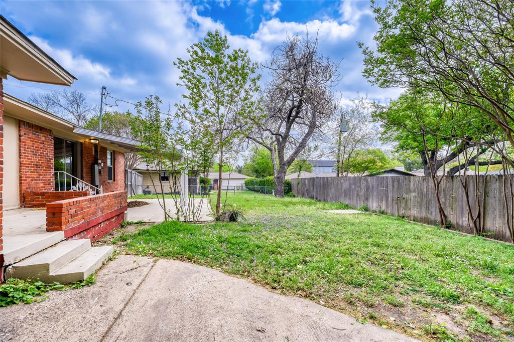 6612 East Mockingbird Lane Dallas, TX 75214 - Photo 25 of 28 a front view of a house with a yard table and chairs