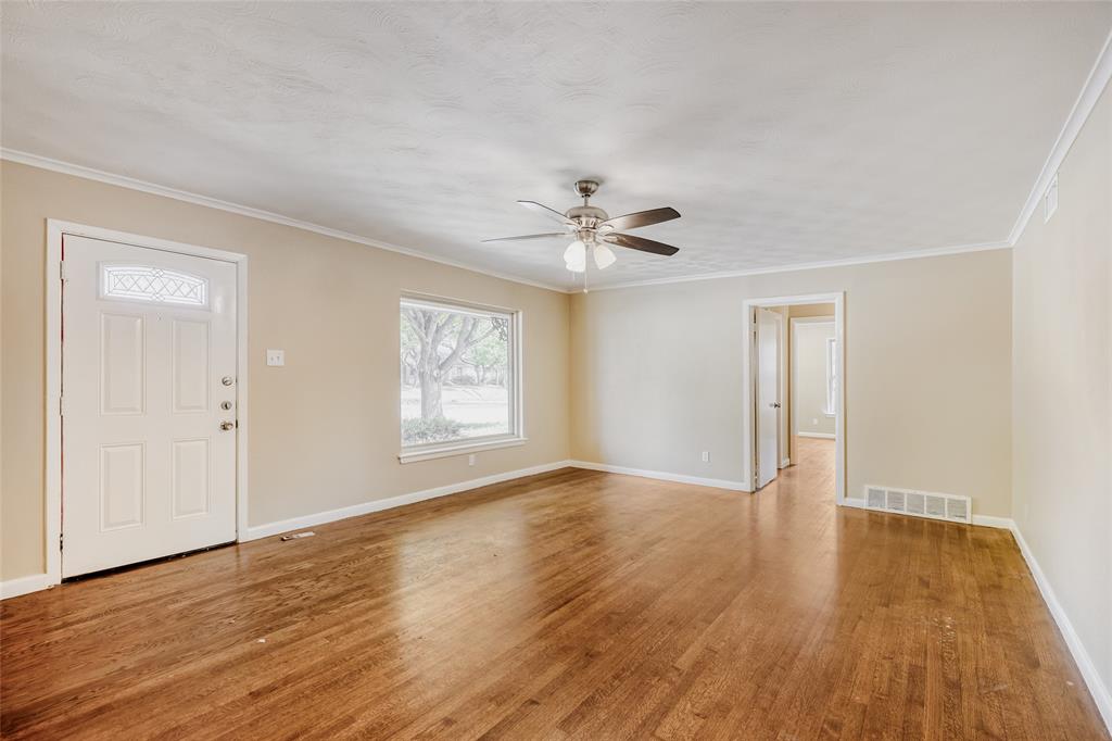6612 East Mockingbird Lane Dallas, TX 75214 - Photo 5 of 28 a view of an empty room with wooden floor and a window