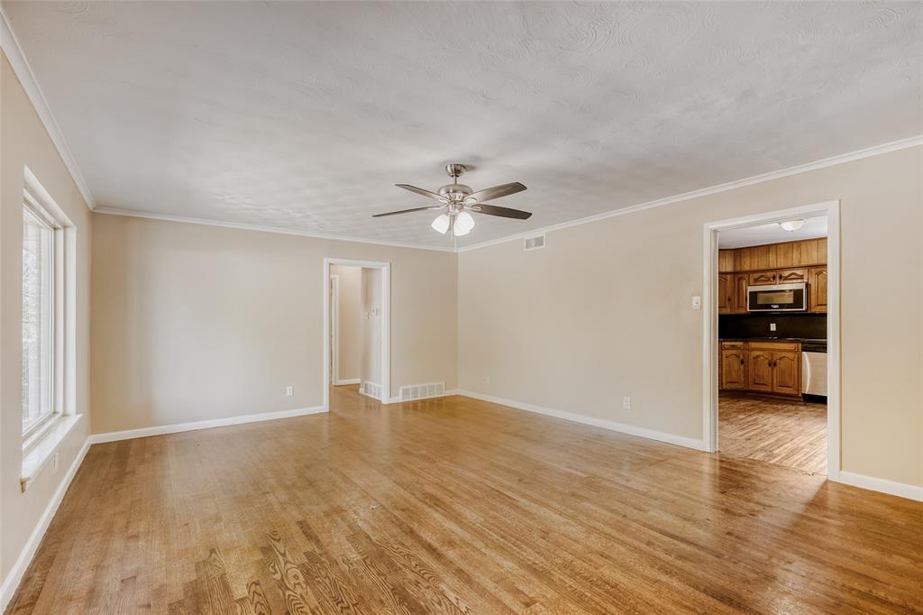 6612 East Mockingbird Lane Dallas, TX 75214 - Photo 6 of 28 a view of an empty room with window and wooden floor