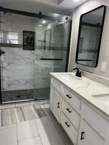 a bathroom with a double vanity sink and mirror