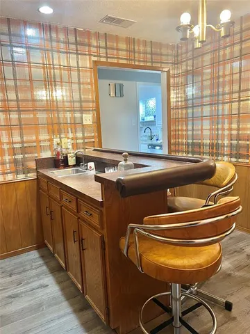 a room with pool table and windows