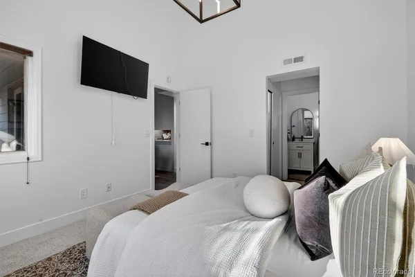 a bedroom with a bed and flat screen tv