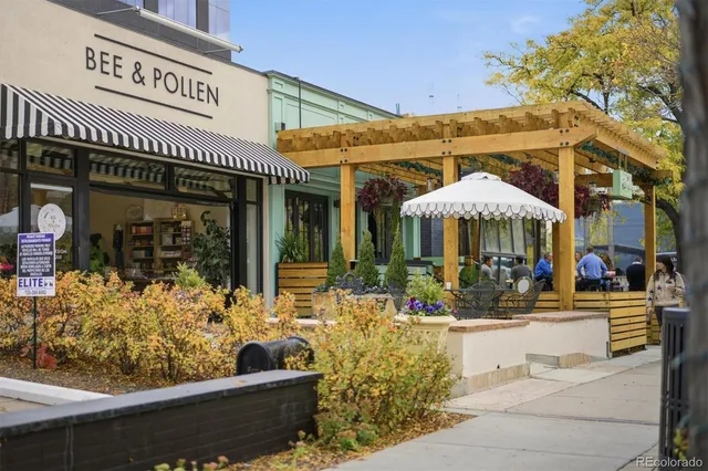 a view of a cafe with a couple of people seating