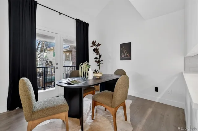 a dining room with furniture and wooden floor