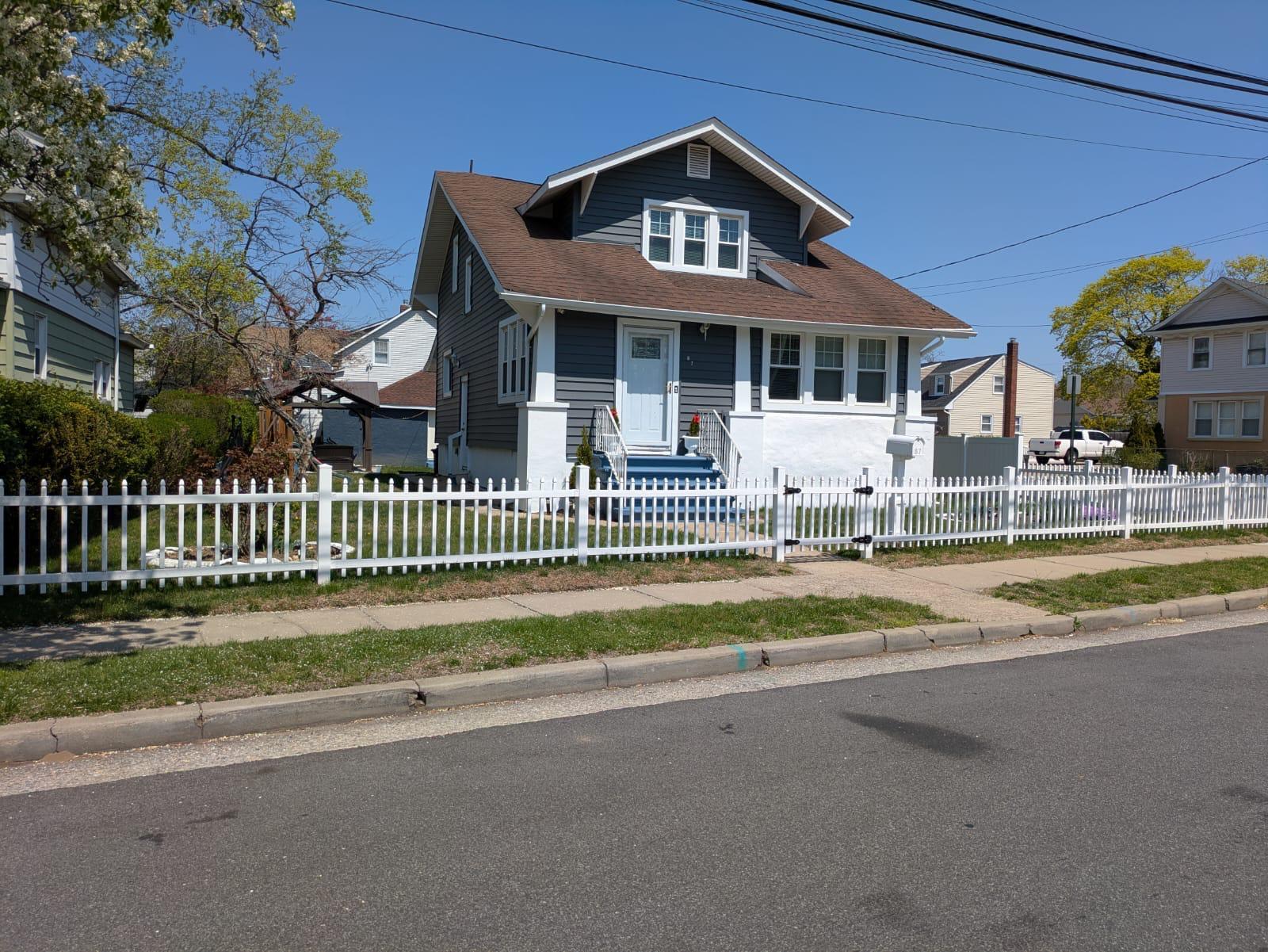 87 Hillside Avenue Freeport, NY 11520 - Photo 1 of 1 a front view of a house with a yard table and chairs