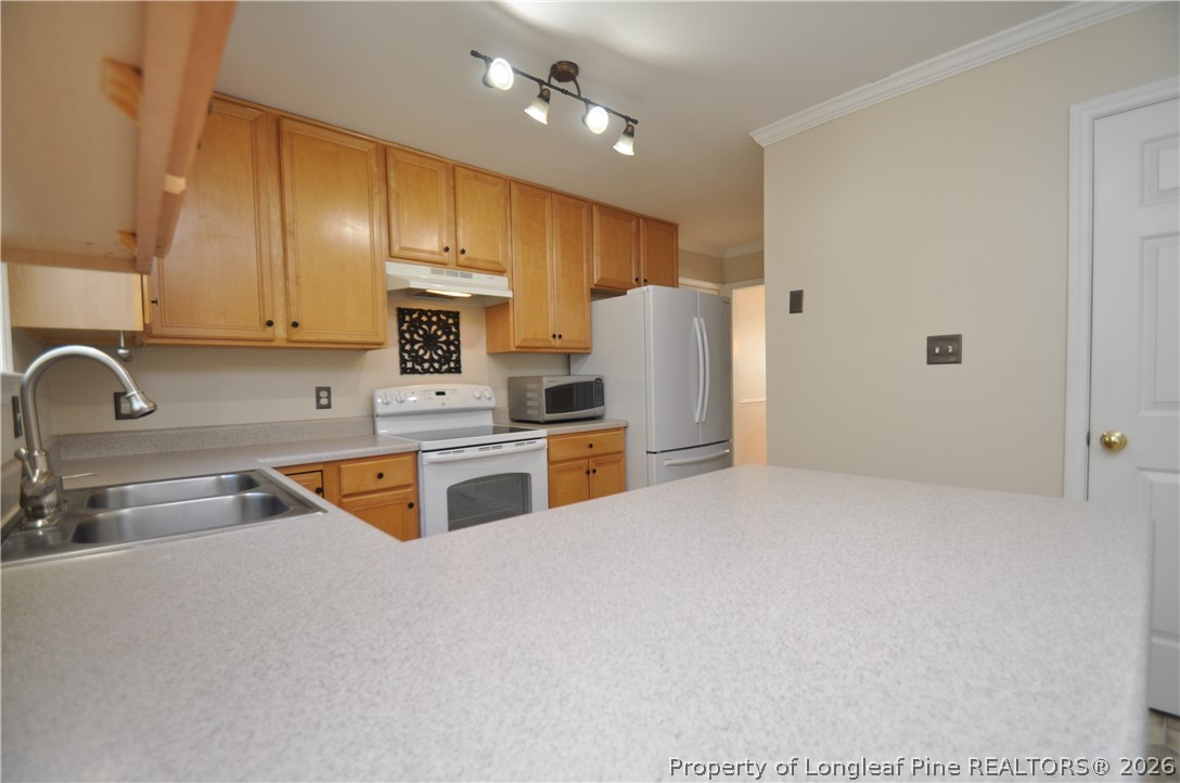 1404 Woodline Drive Raleigh, NC 27603 - Photo 11 of 35 a kitchen with stainless steel appliances granite countertop a sink a stove and a refrigerator with cabinets