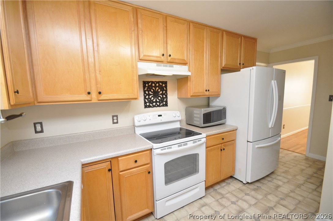 1404 Woodline Drive Raleigh, NC 27603 - Photo 13 of 35 a kitchen with a stove a refrigerator and a sink