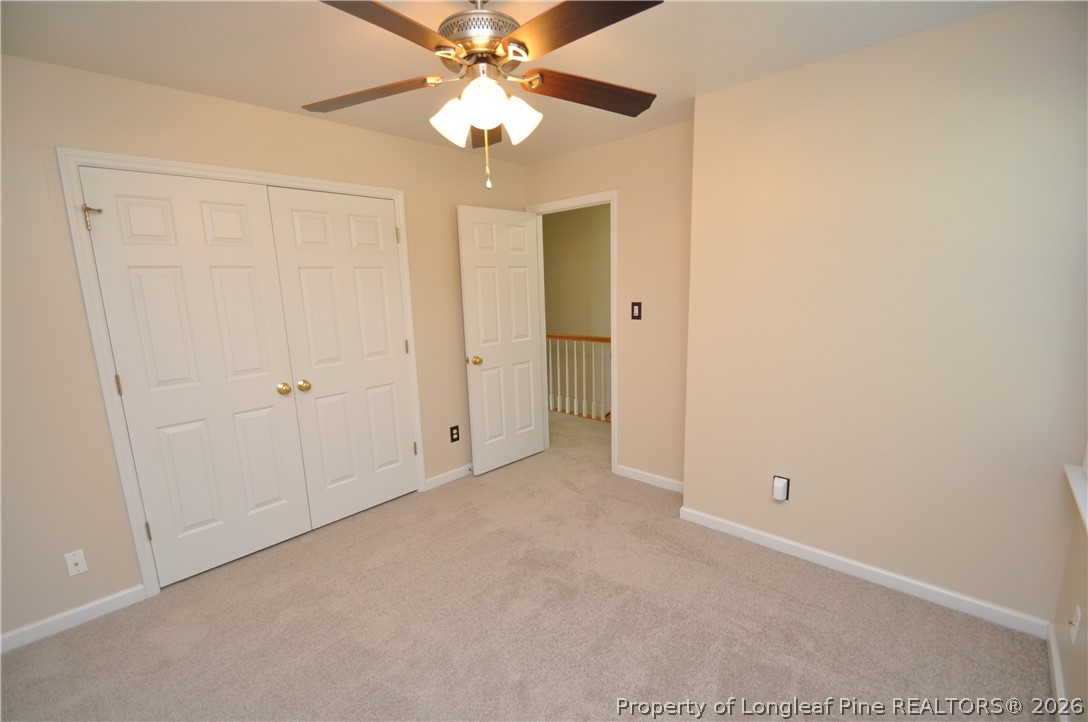 1404 Woodline Drive Raleigh, NC 27603 - Photo 25 of 35 an empty room with a chandelier fan and closet
