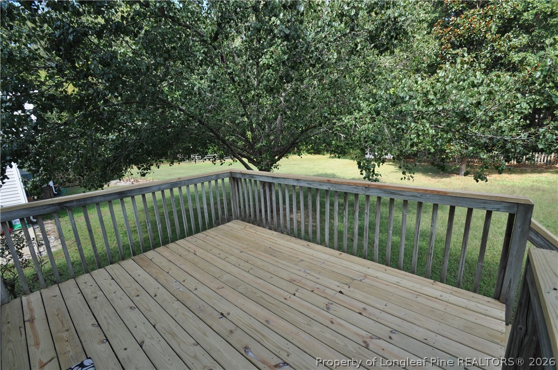 1404 Woodline Drive Raleigh, NC 27603 - Photo 29 of 35 a balcony with wooden floor and trees