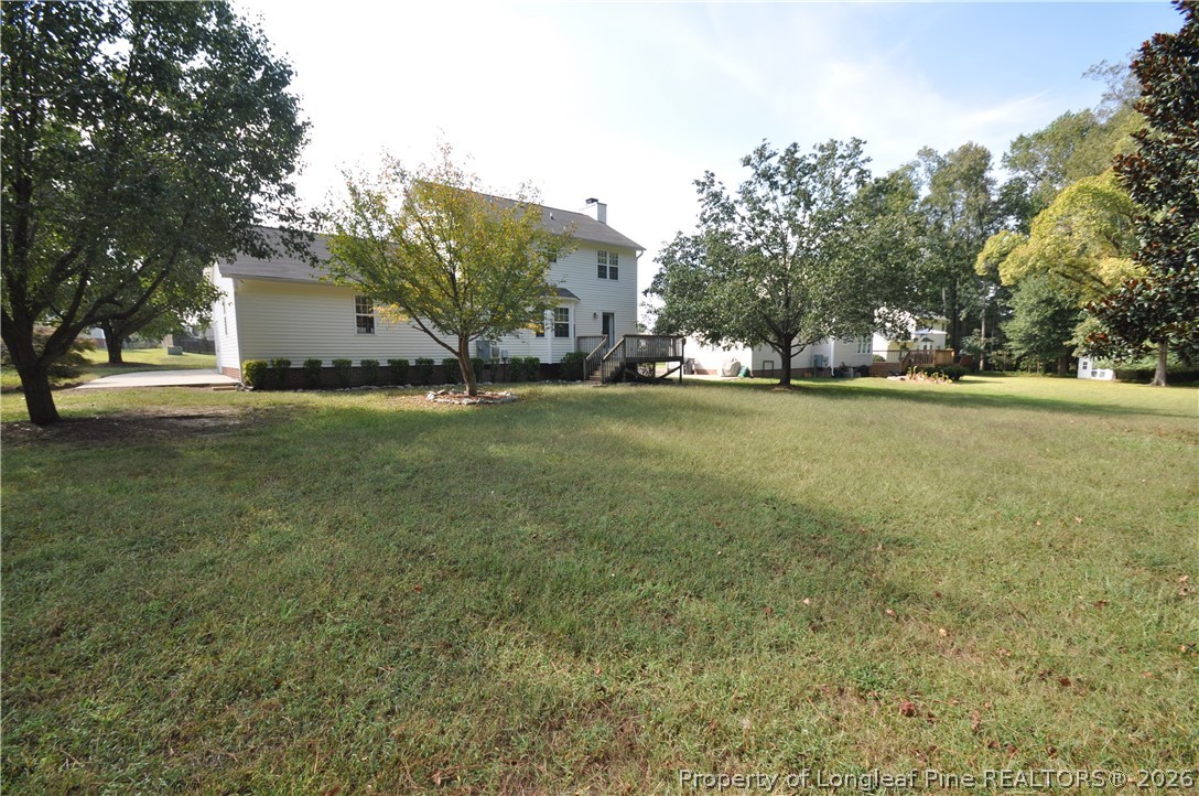 1404 Woodline Drive Raleigh, NC 27603 - Photo 34 of 35 a view of a tree in front of a house