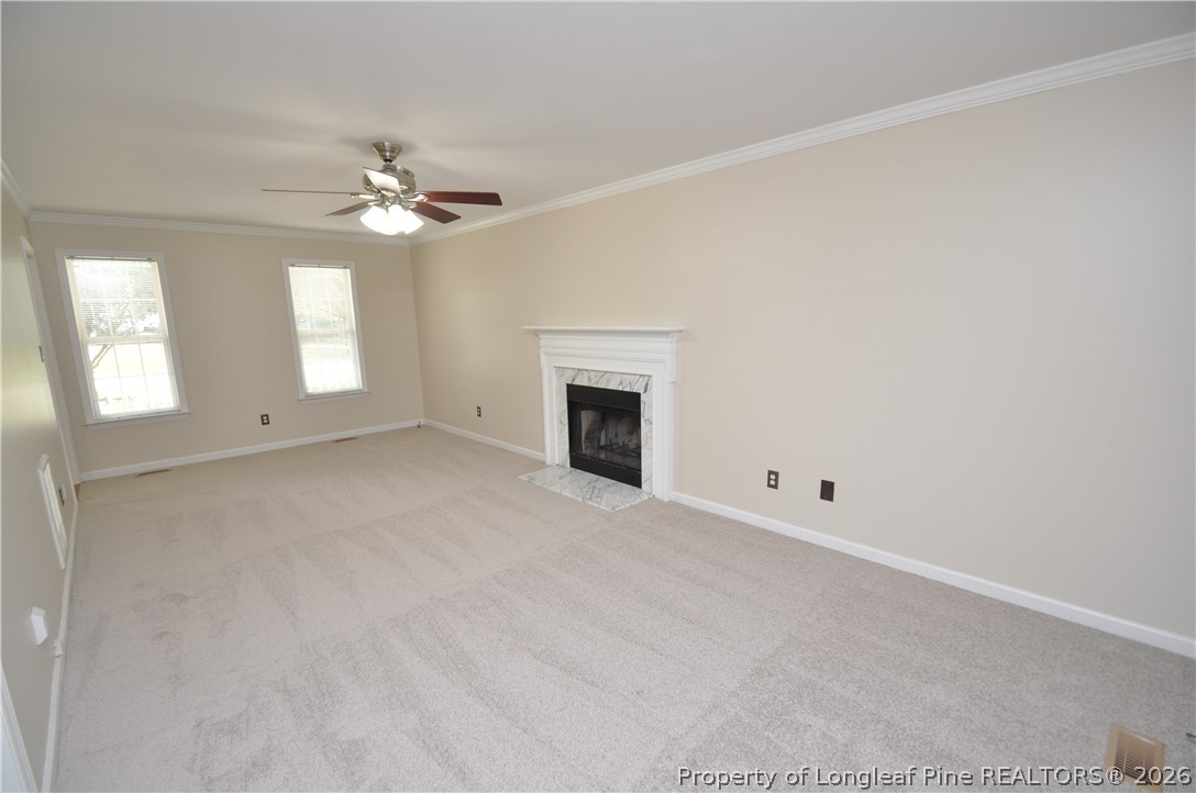 1404 Woodline Drive Raleigh, NC 27603 - Photo 4 of 35 an empty room with windows and fireplace
