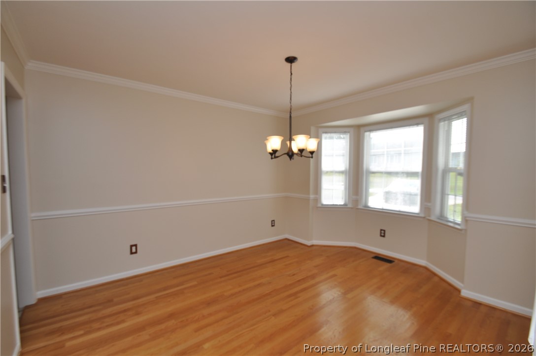 1404 Woodline Drive Raleigh, NC 27603 - Photo 6 of 35 a view of a room with a window and wooden floor