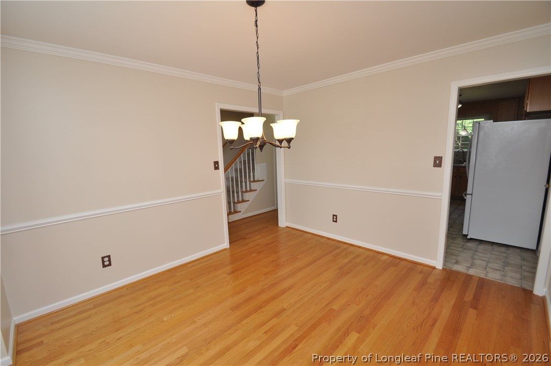 1404 Woodline Drive Raleigh, NC 27603 - Photo 8 of 35 a view of a room with wooden floor and white walls