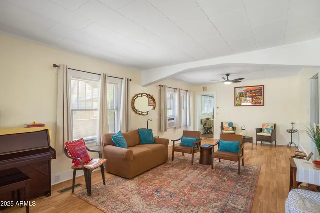 a living room with furniture a rug and a window
