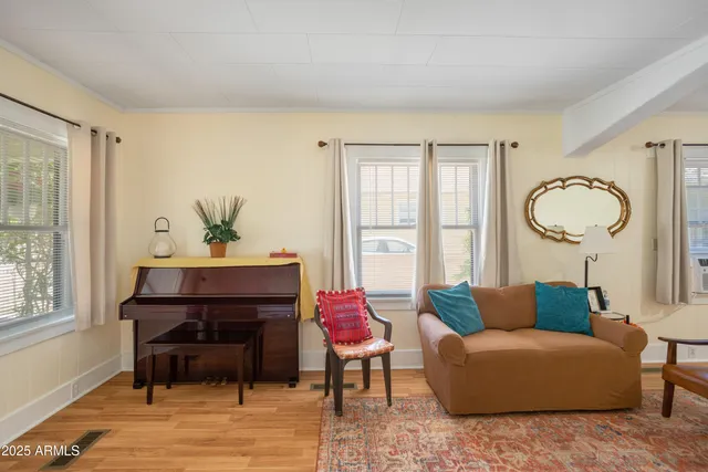 a living room with furniture a table and a window
