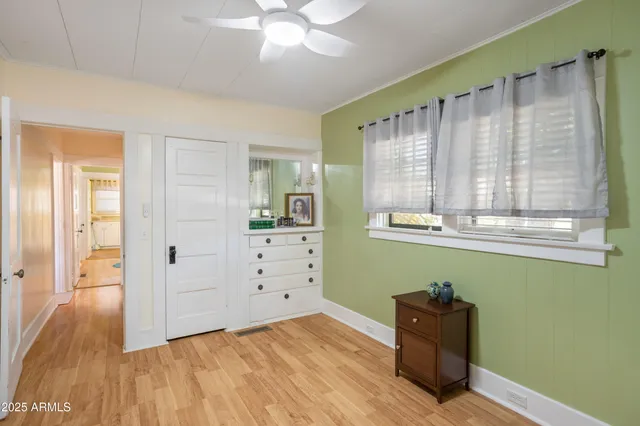 a kitchen with granite countertop a sink cabinets and wooden floor